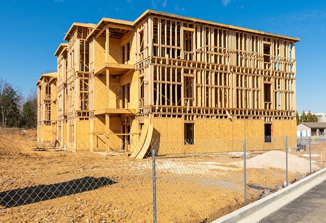 a close-up of temporary chain link fences enclosing a job site, signaling progress in the project's development in Carlsbad TX